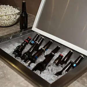 Cooler filled with ice and various beer bottles ready for a party.