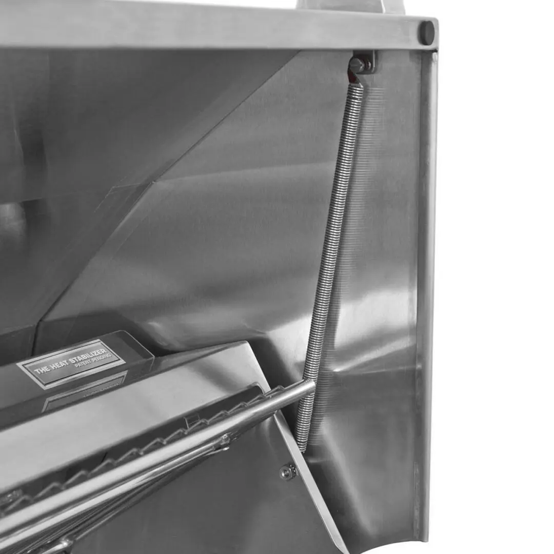 Close-up of a stainless steel kitchen hood with support rods and a grease filter.