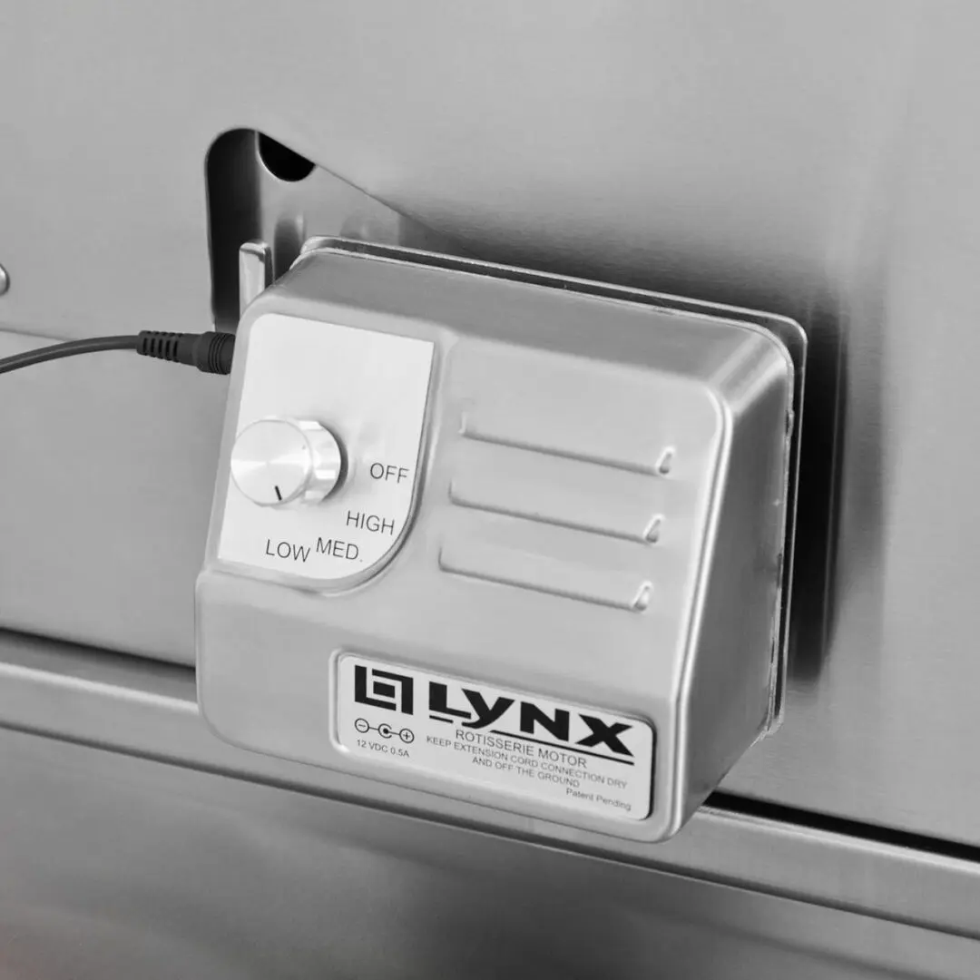 Close-up of a vintage Lynx electronic device plugged into a power outlet.