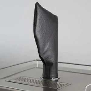 Black leather boot displayed on a metal surface.